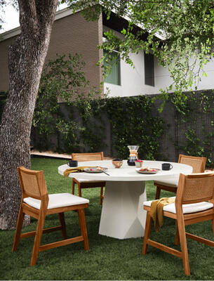 The Bowman outdoor dining table offers impact from every angle with a faceted base cast from smooth concrete. Merit outdoor dining chairs made of FSC-certified teak 